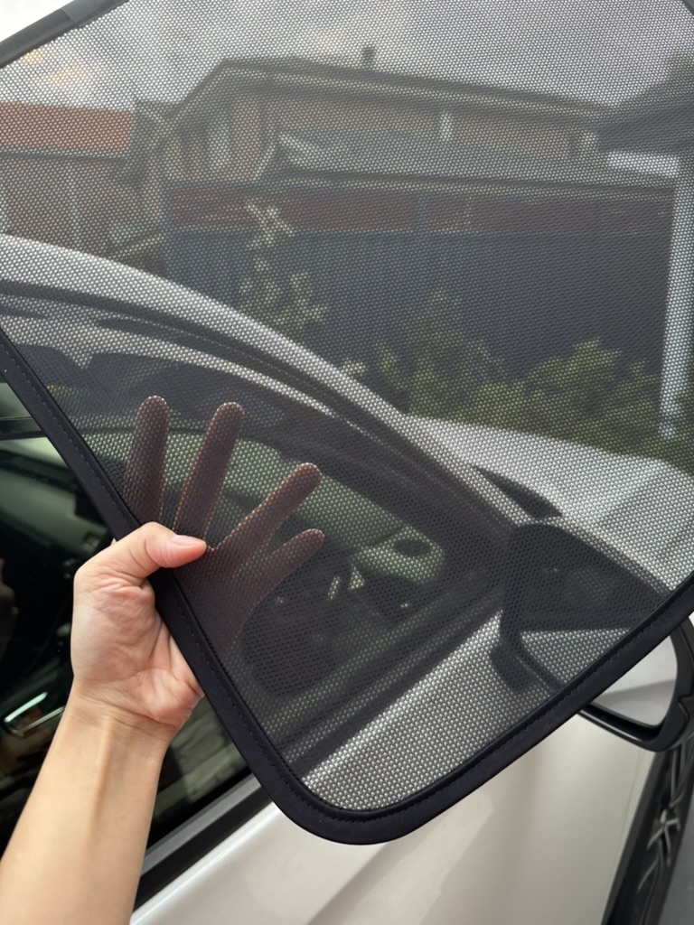 Custom-fit magnetic car window sun shade fitted to a rear door